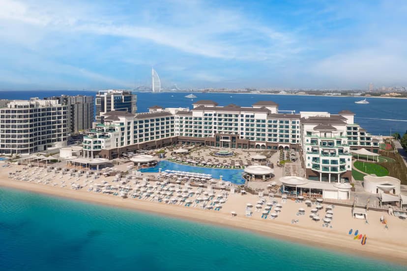 Hero/establishing shot of Taj Exotica Resort & Spa, The Palm, Dubai. Indian ‘Tajness’ hospitality on Palm Jumeirah’s East Crescent — 325 rooms and suites, the longest pool on the crescent at around 70 metres, and standout Indian fine dining at Varq with rooftop skyline dining at Raia.