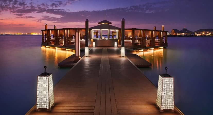 Hero/establishing shot of Banana Island Resort Doha by Anantara, Doha, Qatar. Doha’s overwater-villa island escape, reached by a 20-minute catamaran from the Corniche — an alcohol-free, family-first private-island resort.