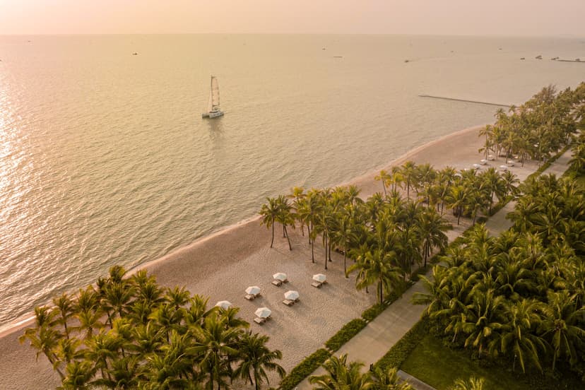 Hero/establishing shot of Regent Phu Quoc, Phu Quoc, Vietnam. The first Regent resort in Southeast Asia — an all-suite-and-villa beachfront icon on Long Beach, beside a UNESCO World Biosphere Reserve, with famous Phu Quoc sunsets.