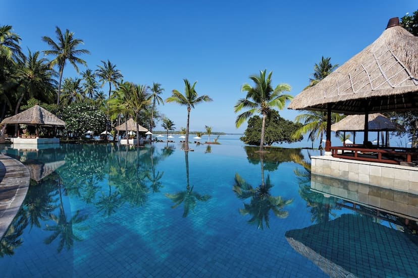 Hero/establishing shot of The Oberoi Beach Resort, Lombok, Lombok, Indonesia. A Peter Muller-designed Oberoi on Lombok’s Medana Bay, facing the Gili Islands (and Bali’s Mount Agung at sunset) — 24 acres of tropical gardens on a private whit