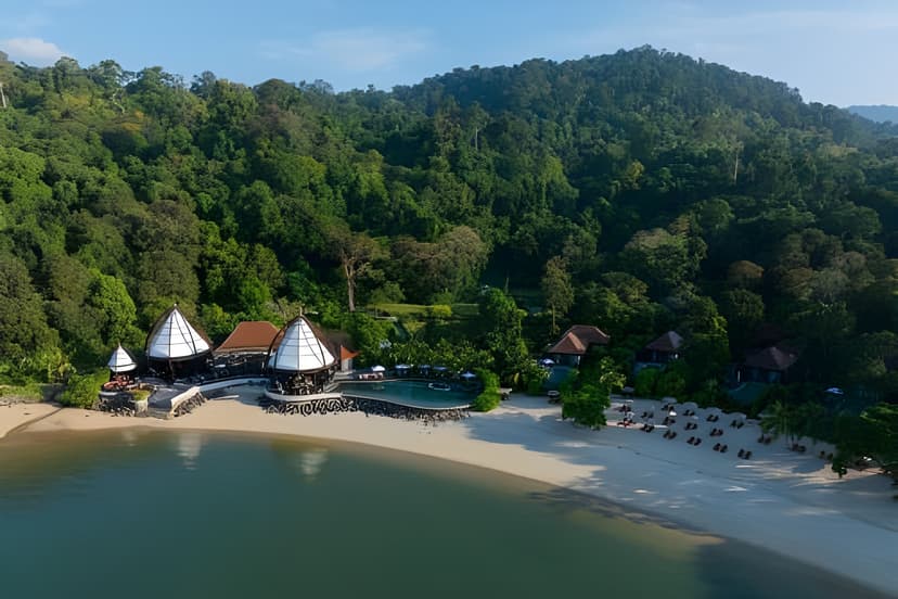 Hero/establishing shot of The Ritz-Carlton, Langkawi, Langkawi, Malaysia. The newest of Langkawi’s big-three resorts, in a private southwest-coast bay within a 10-million-year-old rainforest beneath Mount Machinchang — home to the island’s 