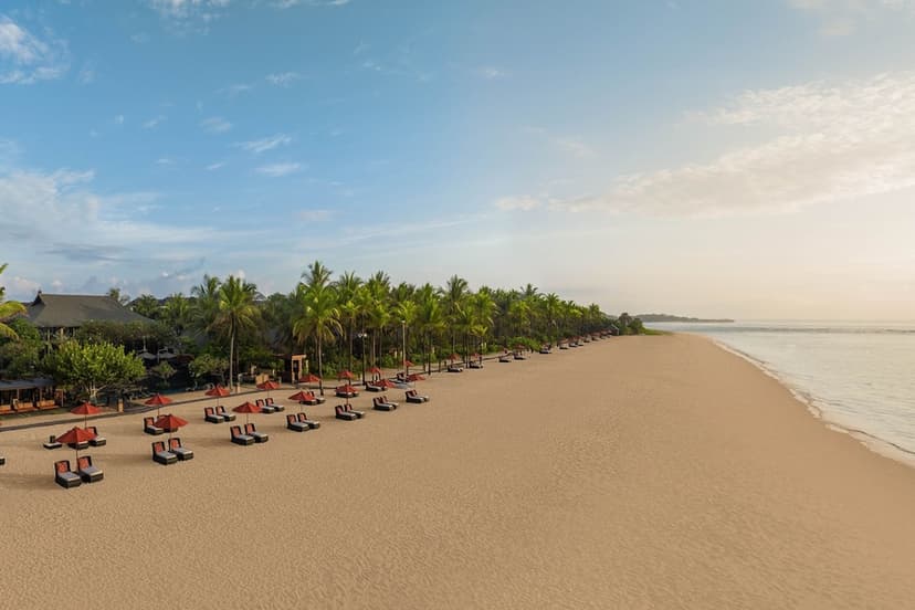 Hero/establishing shot of The St. Regis Bali Resort, Nusa Dua, Bali. The Nusa Dua flagship — an all-suite-and-villa beachfront icon on calm golden sand, built around a 3,668-square-metre saltwater lagoon.