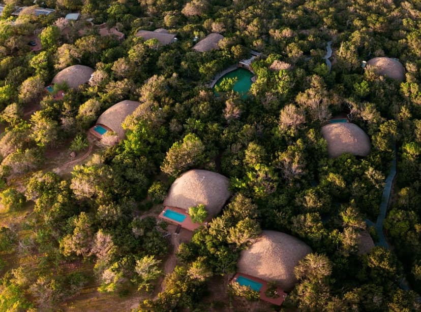 Hero/establishing shot of Uga Chena Huts (Yala), Yala, Sri Lanka. An all-inclusive luxury safari camp on the edge of Yala National Park — the world’s highest leopard density — between the park and the Indian Ocean.