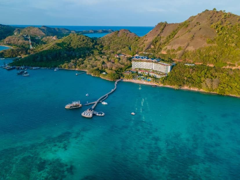 Hero/establishing shot of Ayana Komodo Waecicu Beach, Labuan Bajo, Indonesia. The Labuan Bajo gateway to Komodo National Park — the first world-class luxury resort in Komodo, on a cliff and beachfront over the Flores Sea facing Kukusan Isla