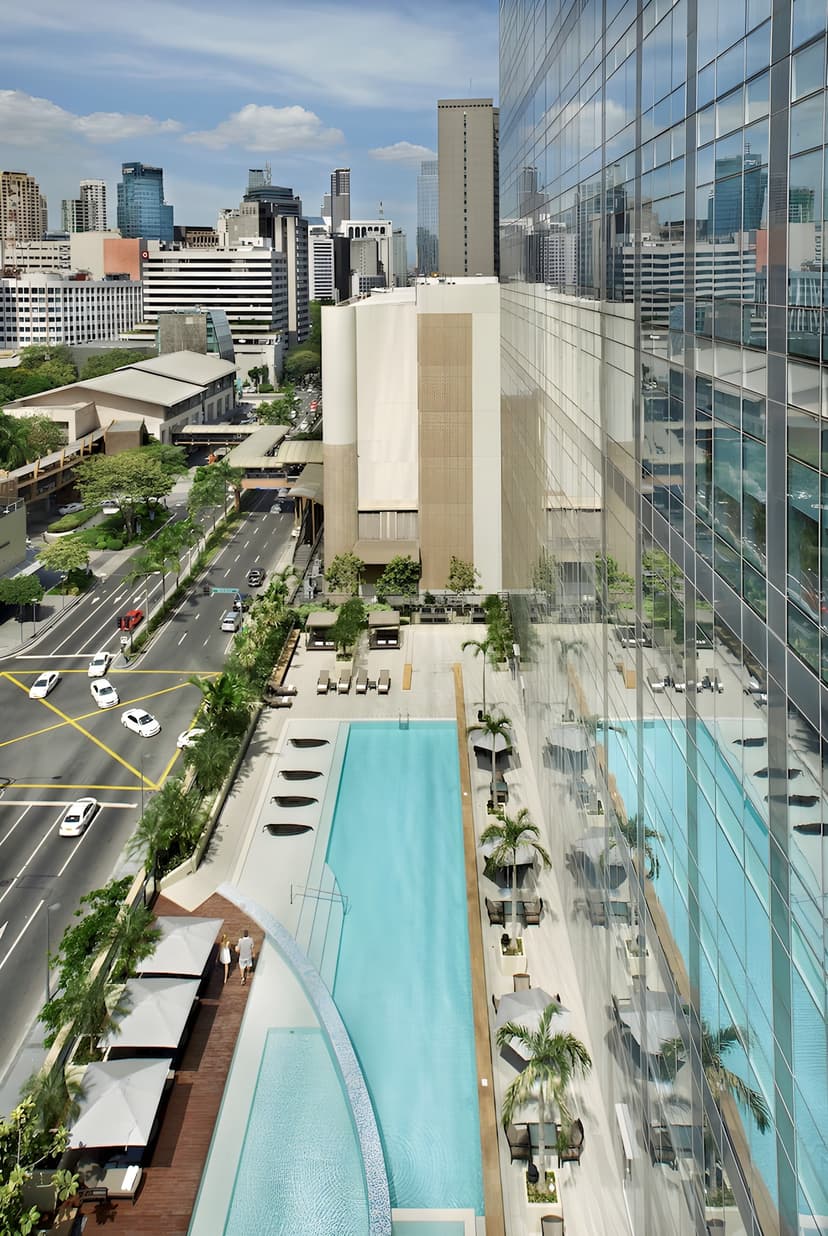 Hero/establishing shot of Fairmont Makati, Manila, Philippines. A five-star tower in the heart of the Makati CBD, Manila — the natural city bookend for a Philippine island itinerary, a three-minute walk from the Greenbelt and Glorietta mall