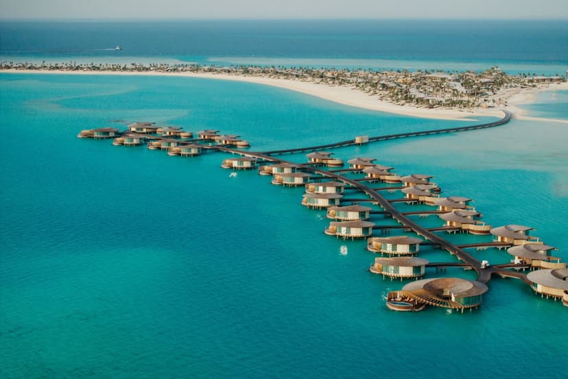 Hero/establishing shot of The St. Regis Red Sea Resort, The Red Sea, Saudi Arabia. Saudi’s first private-island overwater resort, on Ummahat Island in The Red Sea — 90 villas, each with a private pool, designed by Kengo Kuma and reached by seaplane or boat among untouched coral reefs.