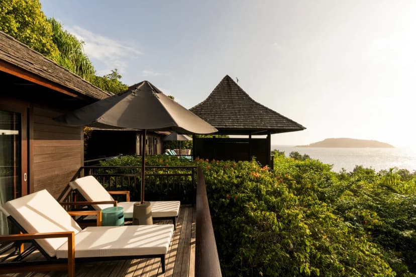 Signature hero of Constance Ephelia (Port Launay, Mahé, Seychelles): the single most iconic wide view — Two beaches, Activity-rich, Marine park. Golden-hour, landscape, room to overlay text.