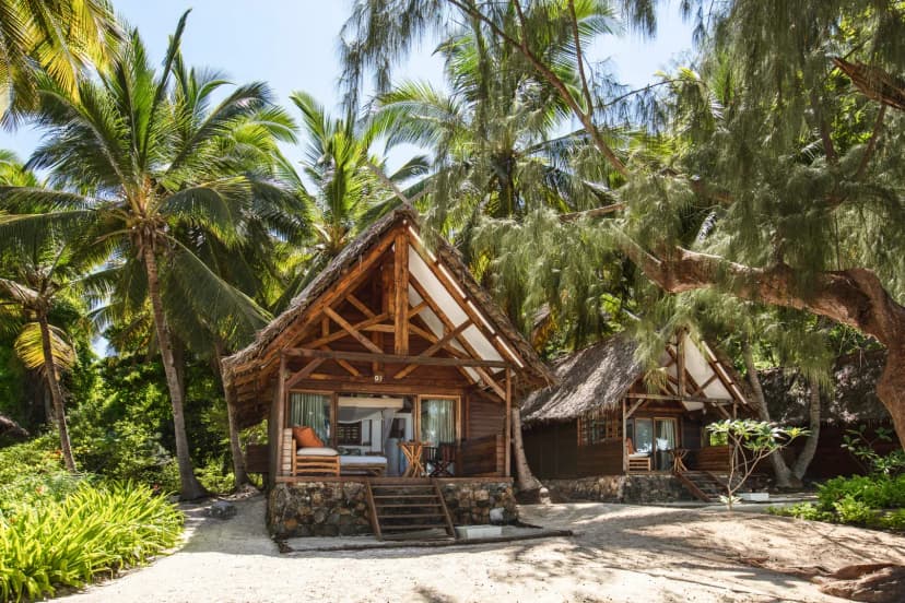 Signature hero of Constance Tsarabanjina (Mitsio Archipelago, Madagascar): the single most iconic wide view — Castaway island, All-inclusive, Barefoot luxury. Golden-hour, landscape, room to overlay text.