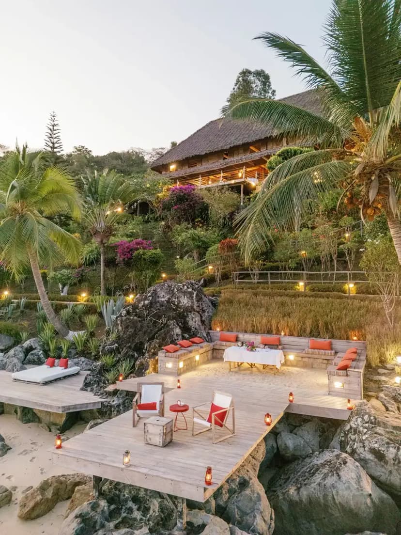 Signature hero of Time + Tide Tsara Komba (Nosy Komba, Madagascar): the single most iconic wide view — Lemur Island, Eight villas, Forest-to-reef. Golden-hour, landscape, room to overlay text.