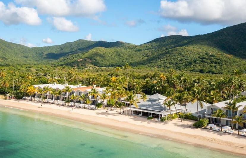 Hero/establishing shot of Carlisle Bay, Antigua. A contemporary all-suite Leading Hotels of the World resort in a horseshoe bay between beach and rainforest.