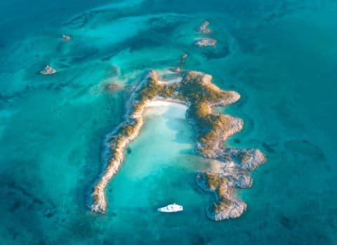 Hero/establishing shot of Kamalame Cay, Andros, Bahamas. A private ninety-six-acre out-island off Andros, reached by private ferry or seaplane, with the only overwater spa in the Bahamas.