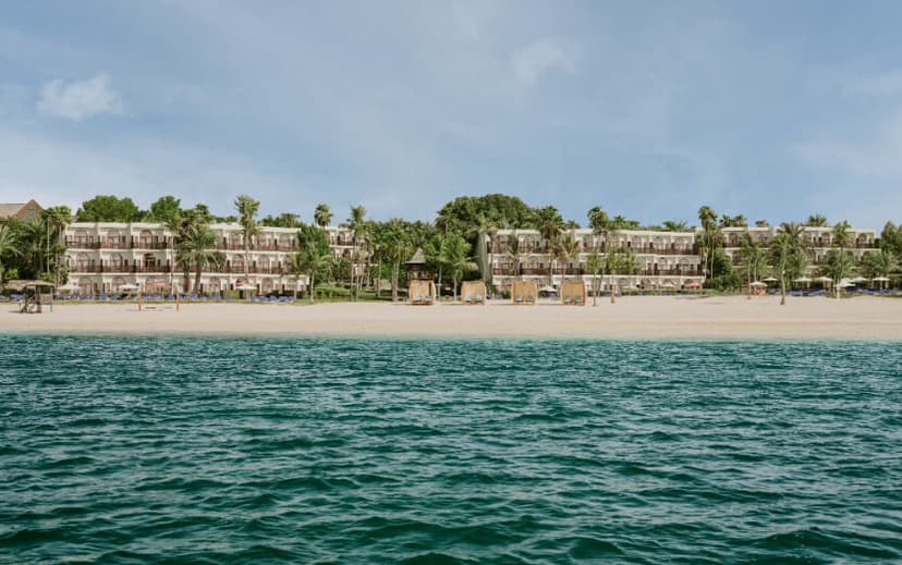 Hero/establishing shot of JA Palm Tree Court, Dubai. An all-suite, all-inclusive-capable family beach resort in the 128-acre JA The Resort estate at Mina Jebel Ali — one of Dubai’s few genuine all-inclusive options.
