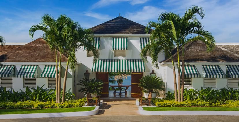 Hero/establishing shot of Round Hill Hotel and Villas, Montego Bay, Jamaica. 1950s glamour on a 110-acre private peninsula near Montego Bay, where JFK and Jackie honeymooned and Ralph Lauren designed the Pineapple House rooms and owns a vil