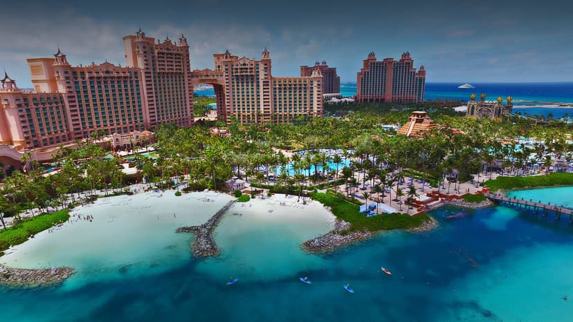 Hero/establishing shot of The Cove at Atlantis, Nassau, Bahamas. The all-suite luxury tower of the Atlantis megaresort on Paradise Island, with butlers and an adults-only Cove pool — and the 141-acre Aquaventure water park, Michelin-chef di