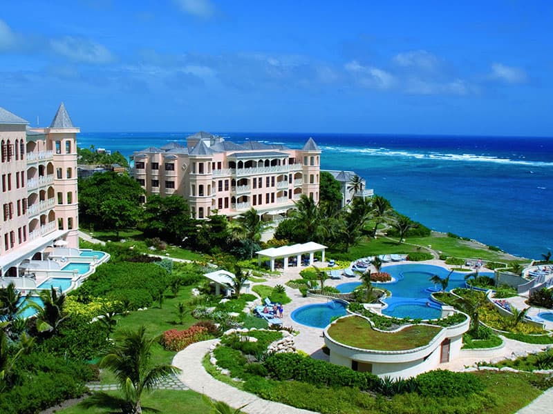 Hero/establishing shot of The Crane Resort, St Philip, Barbados. The oldest continuously operating hotel in the Caribbean, since 1887, set on a cliff above the famous pink sand of Crane Beach on Barbados' characterful south-east coast.