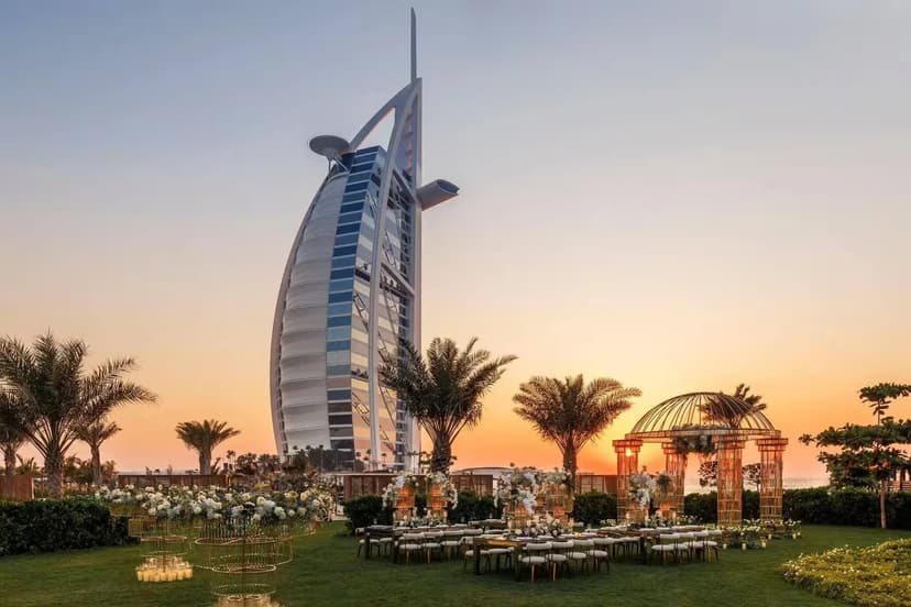 Hero/establishing shot of Burj Al Arab Jumeirah, Dubai. The single most recognisable building in Dubai — an all-suite sail-shaped landmark on its own island, reached by causeway.