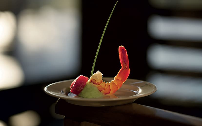 Relais & Châteaux table — the activity/scene in action. French-Malagasy cooking in the wild.