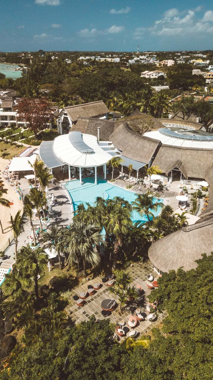 Signature hero of LUX* Grand Gaube (North Coast, Mauritius): the single most iconic wide view — Retro-chic five-star, Lively dining, North coast. Golden-hour, landscape, room to overlay text.