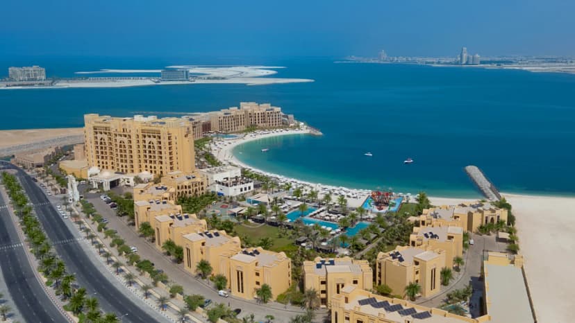 Hero/establishing shot of DoubleTree by Hilton Resort & Spa Marjan Island, Ras Al Khaimah. One of Al Marjan Island’s biggest family resorts — around 723 keys on a 650-metre private beach, with an ultra-all-inclusive option, a water park and a floating sea pool.