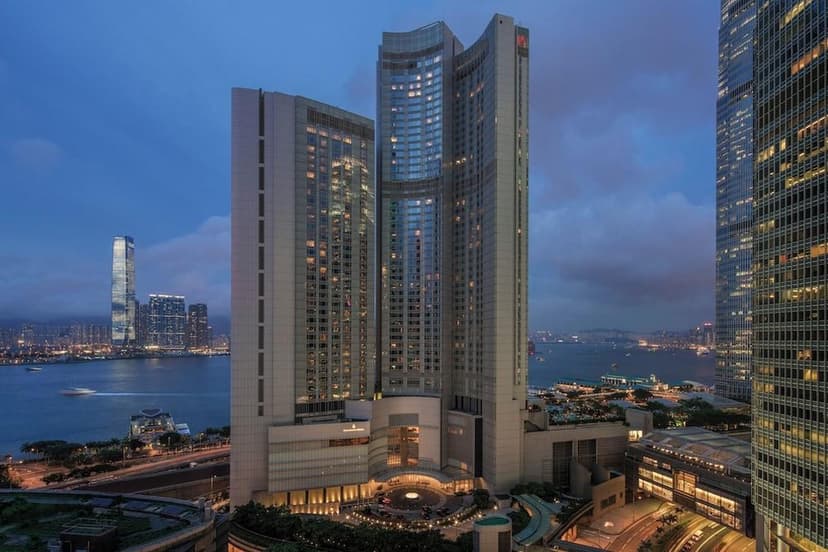 Hero/establishing shot of Four Seasons Hotel Hong Kong, Hong Kong. A Central harbourfront tower connected straight into ifc mall and the Airport Express — a Michelin-dining and infinity-pool powerhouse on Hong Kong Island.