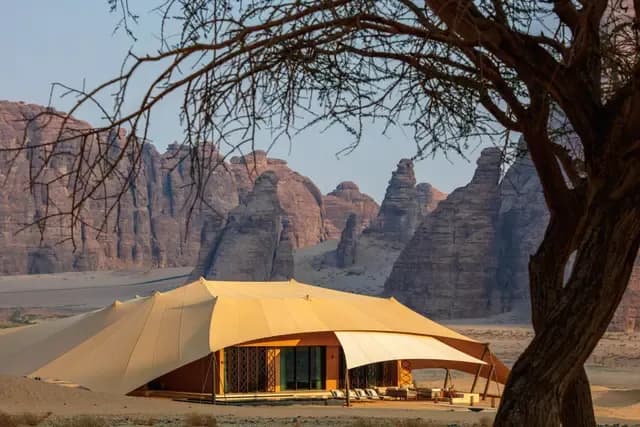 Hero/establishing shot of Banyan Tree AlUla, AlUla, Saudi Arabia. An all-villa desert wellness sanctuary in AlUla’s Ashar Valley, near the UNESCO World Heritage Site of Hegra — 47 tented villas, many with private pools, beneath sandstone cliffs.